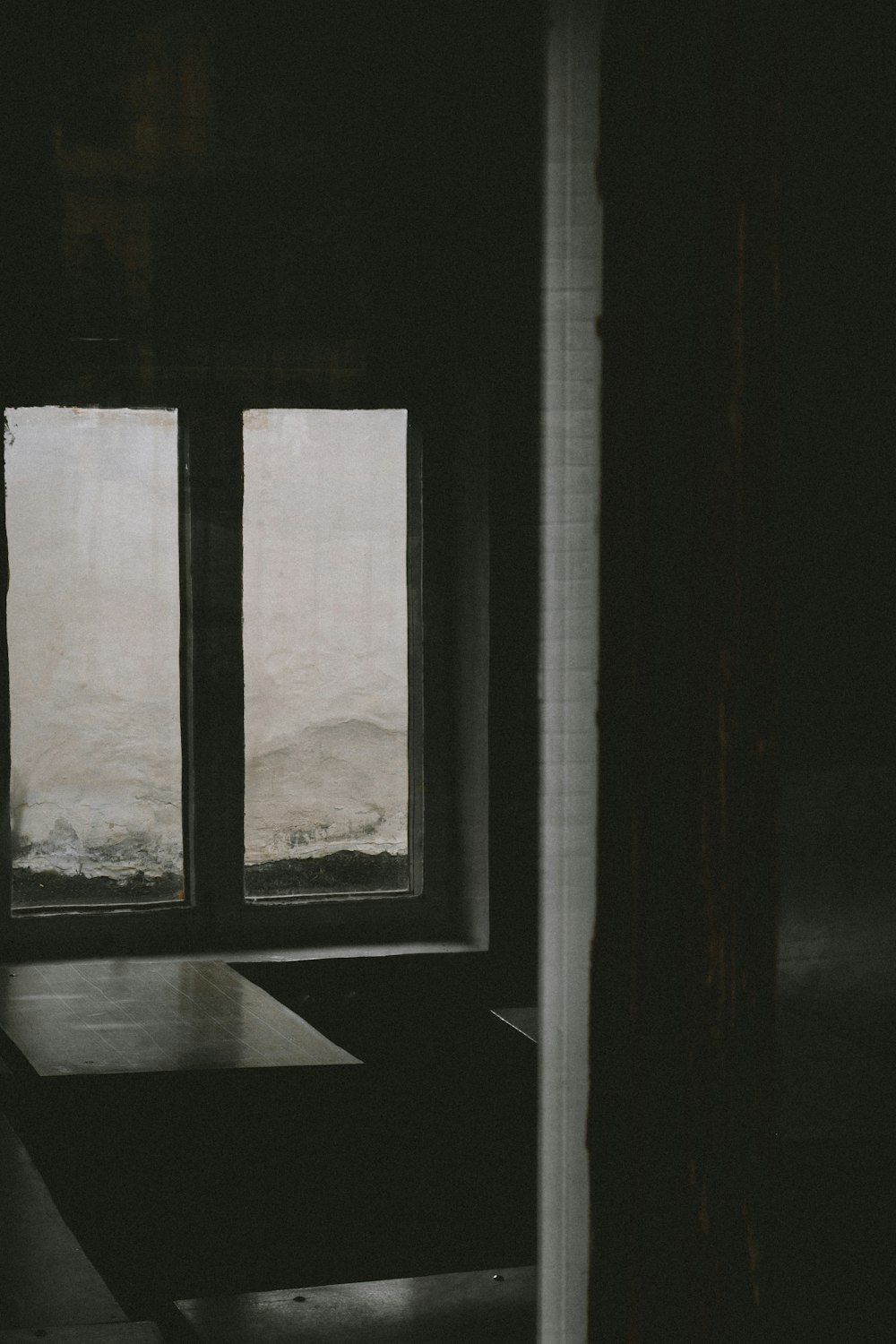 a room with a table and a window with a view of a body of water