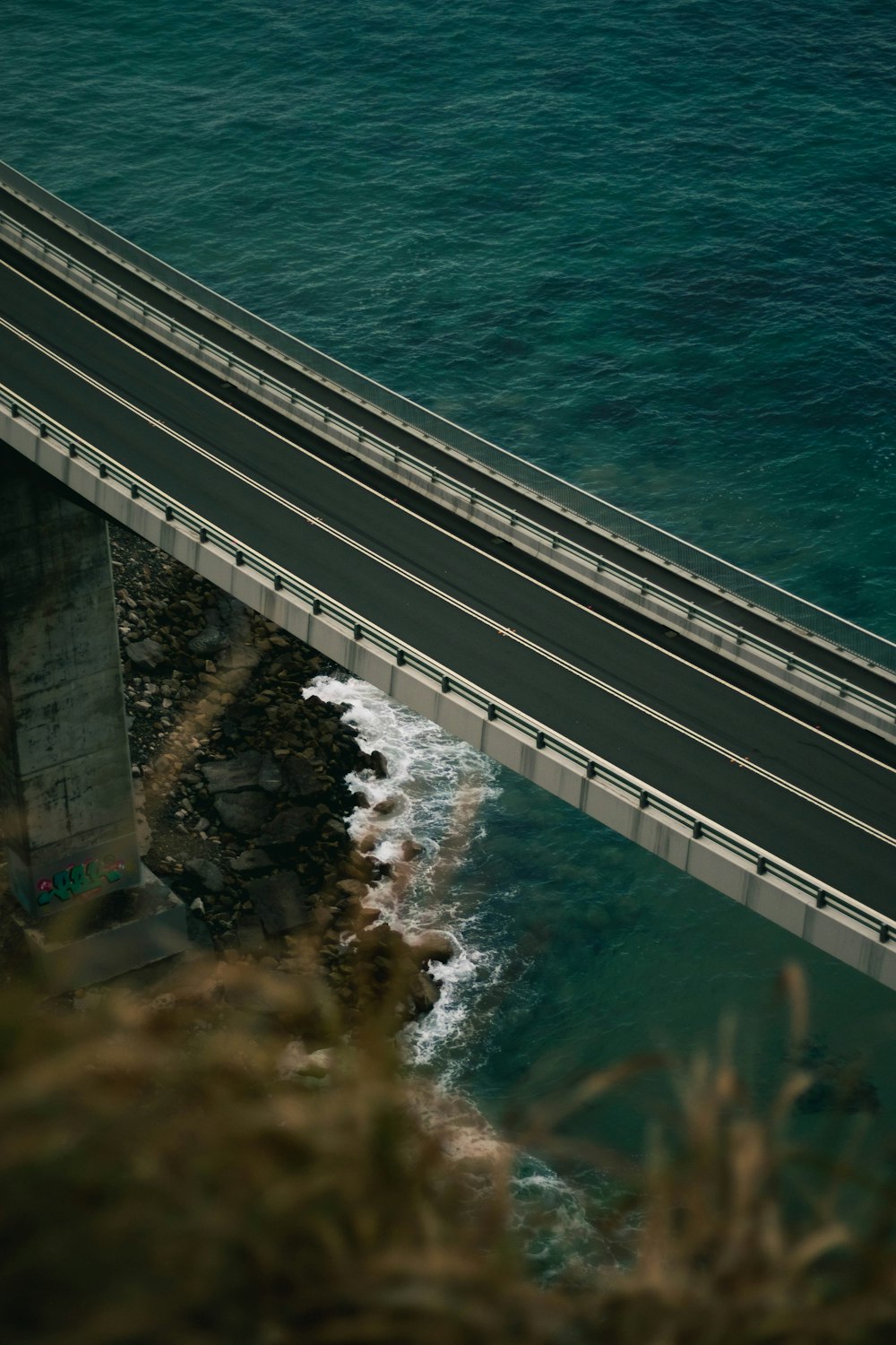 a car driving over a bridge over a body of water