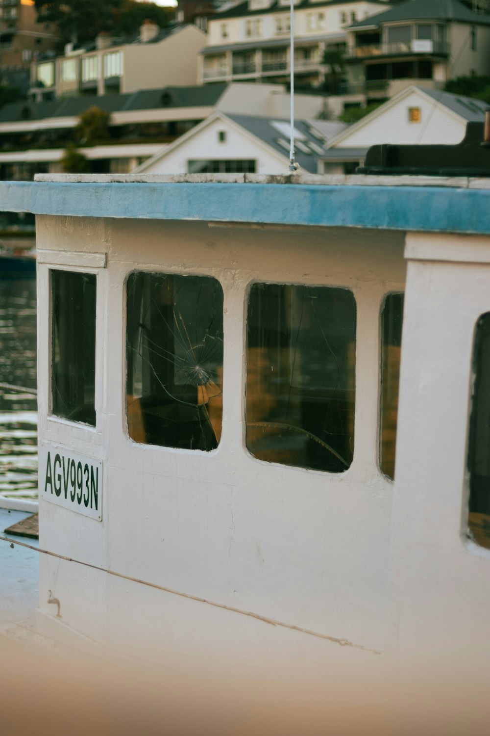 a dog is sitting in the window of a boat