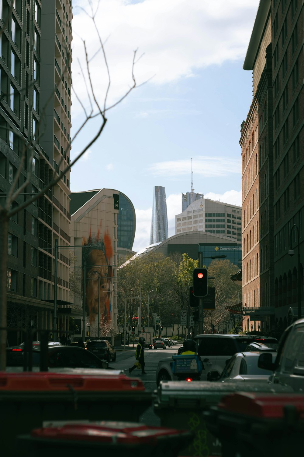 a city street filled with traffic next to tall buildings