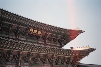 a tall building with a rainbow in the background