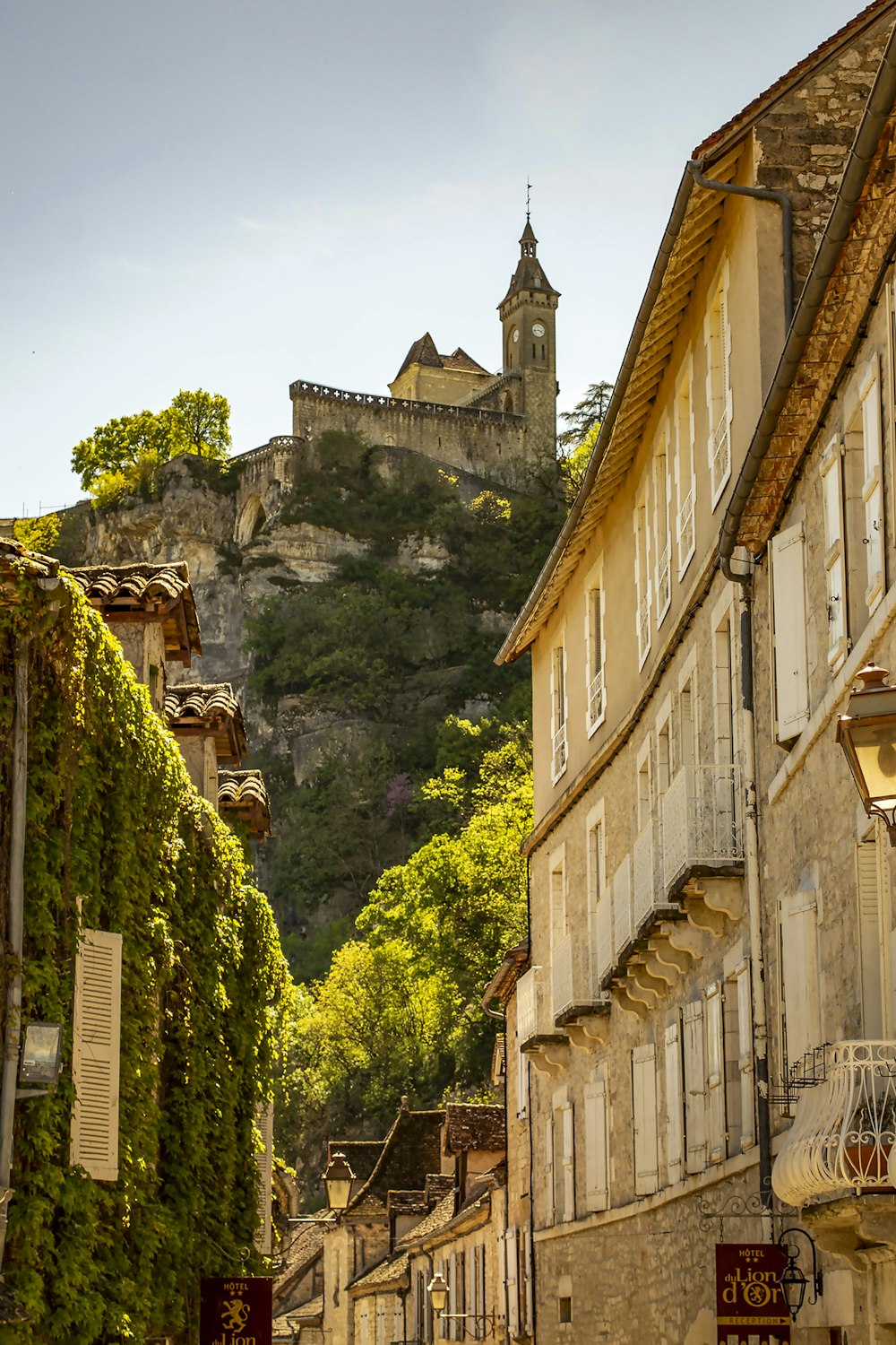 a street with buildings and a castle on a hill in the background