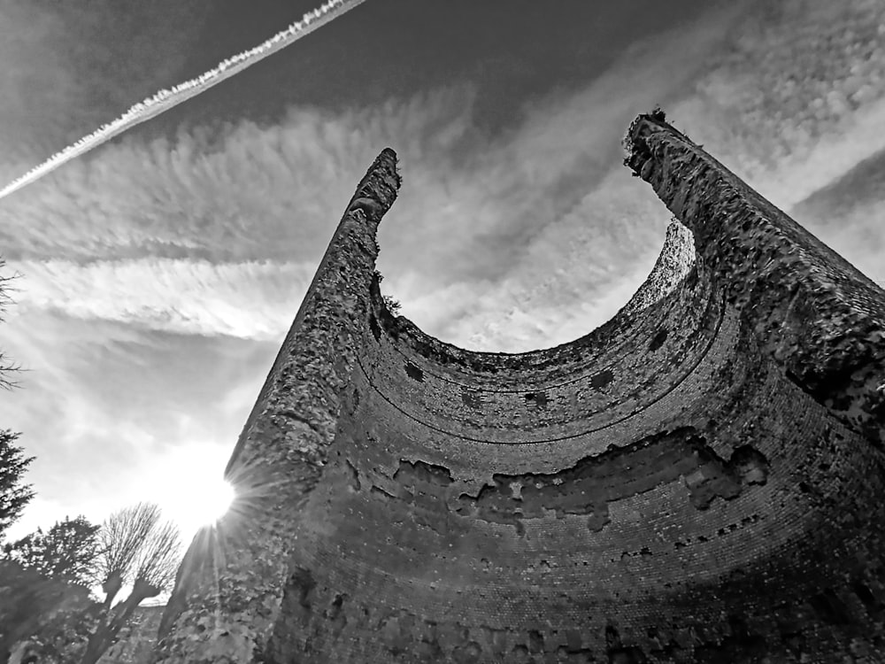 a black and white photo of a plane flying in the sky