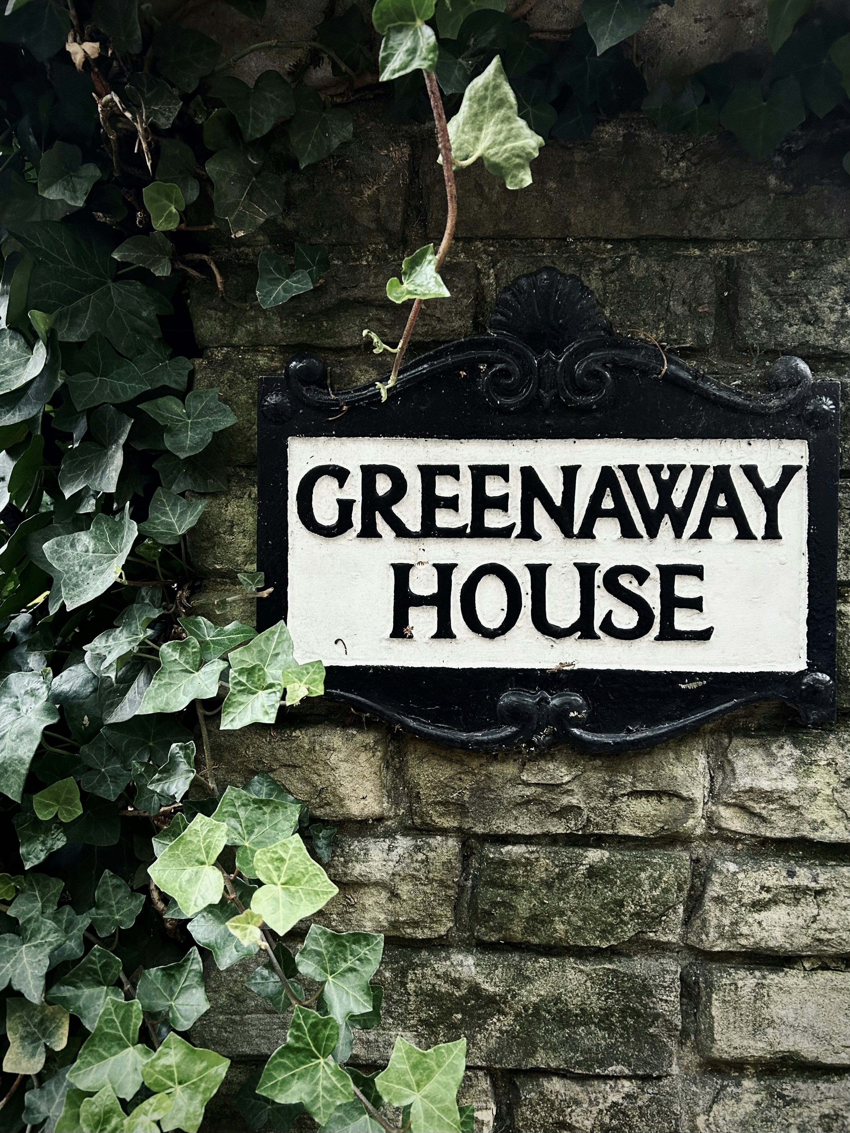 a black and white sign on a brick wall