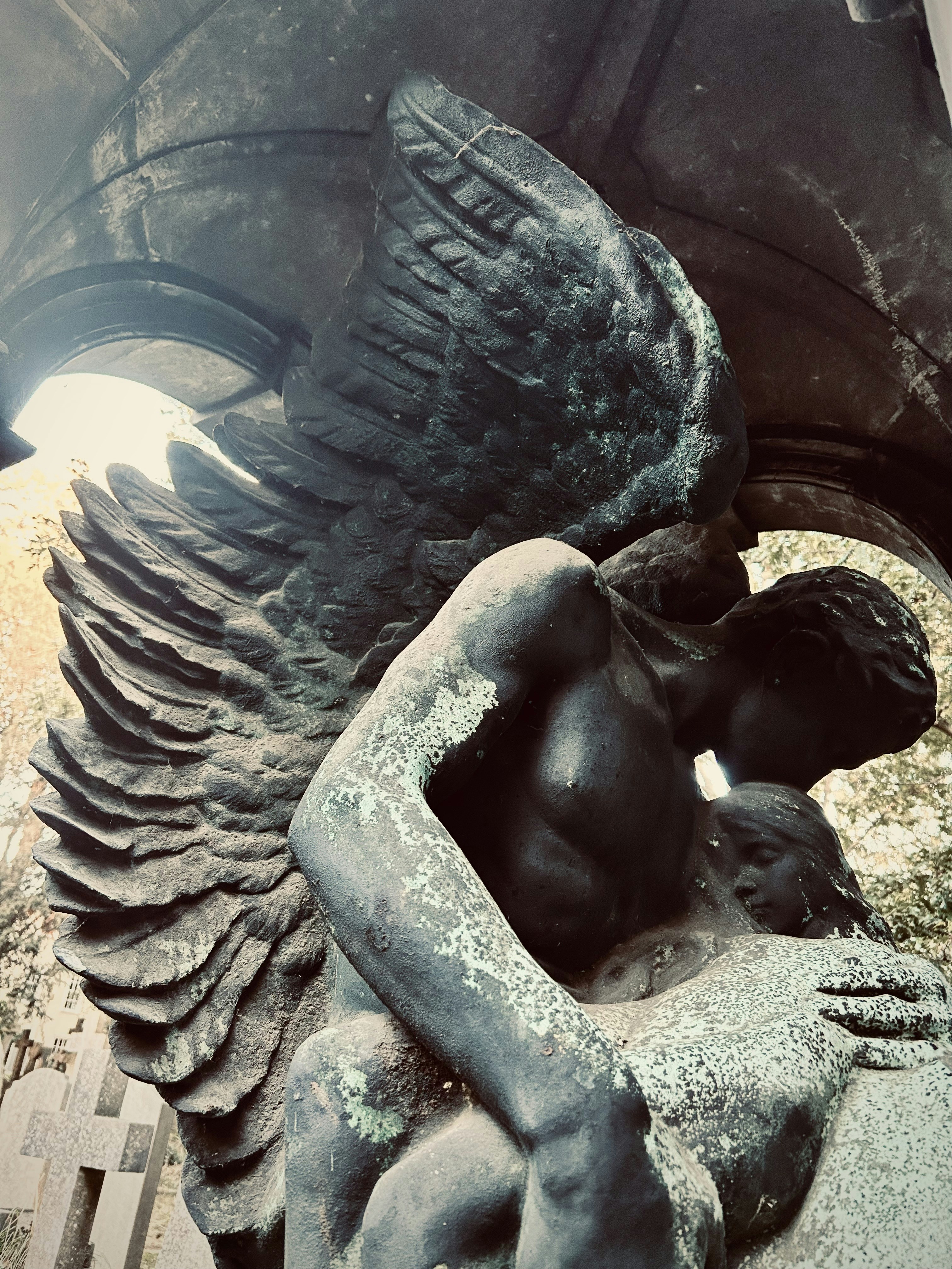 a statue of an angel holding a child