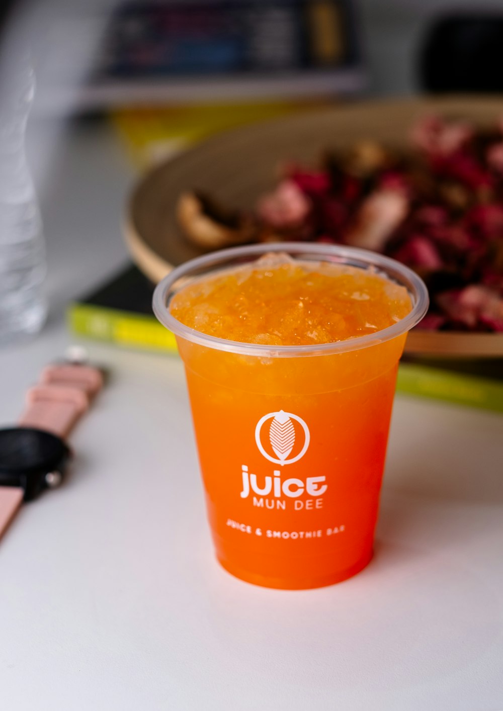 a cup of juice sitting on top of a table