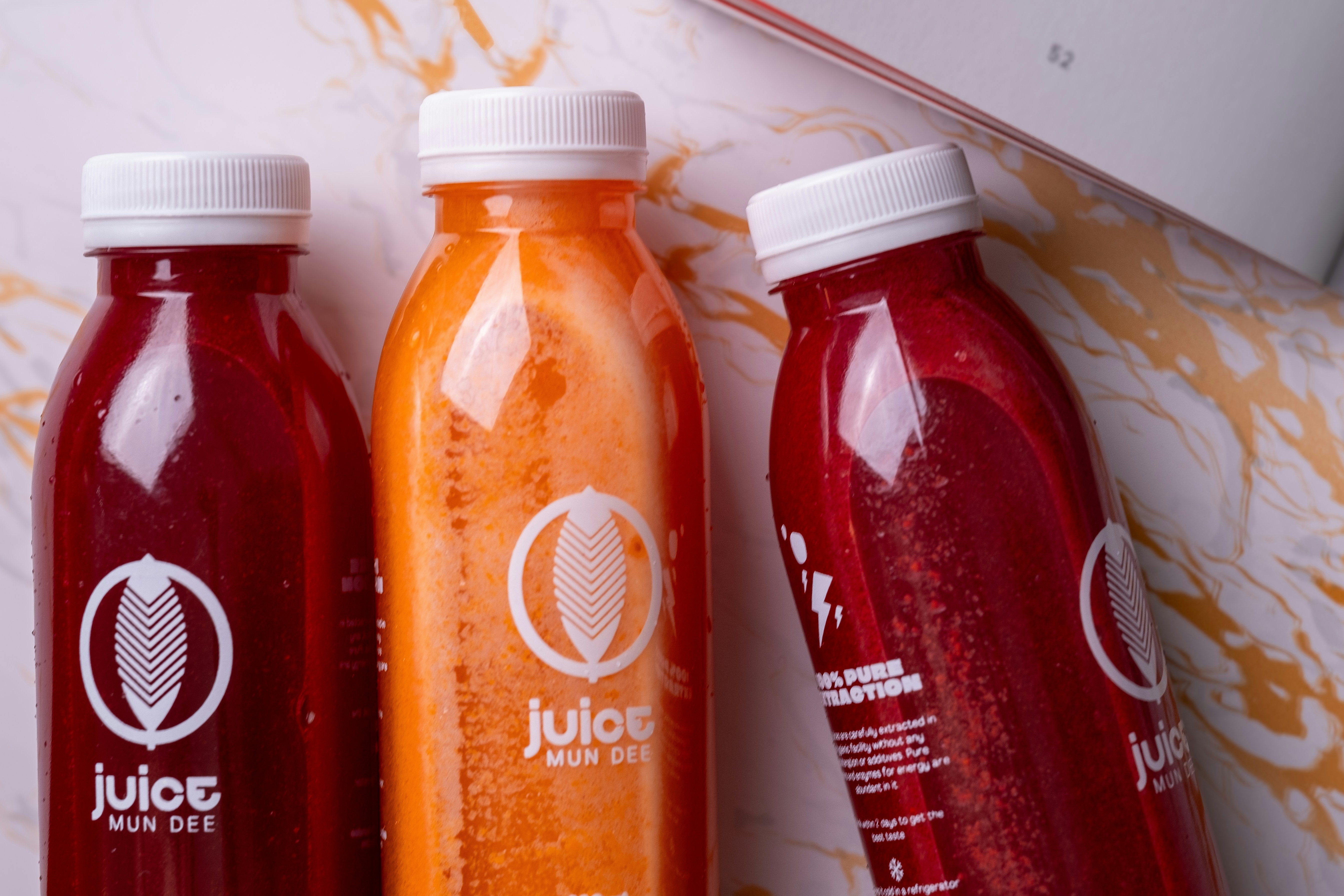 two bottles of juice sitting next to each other