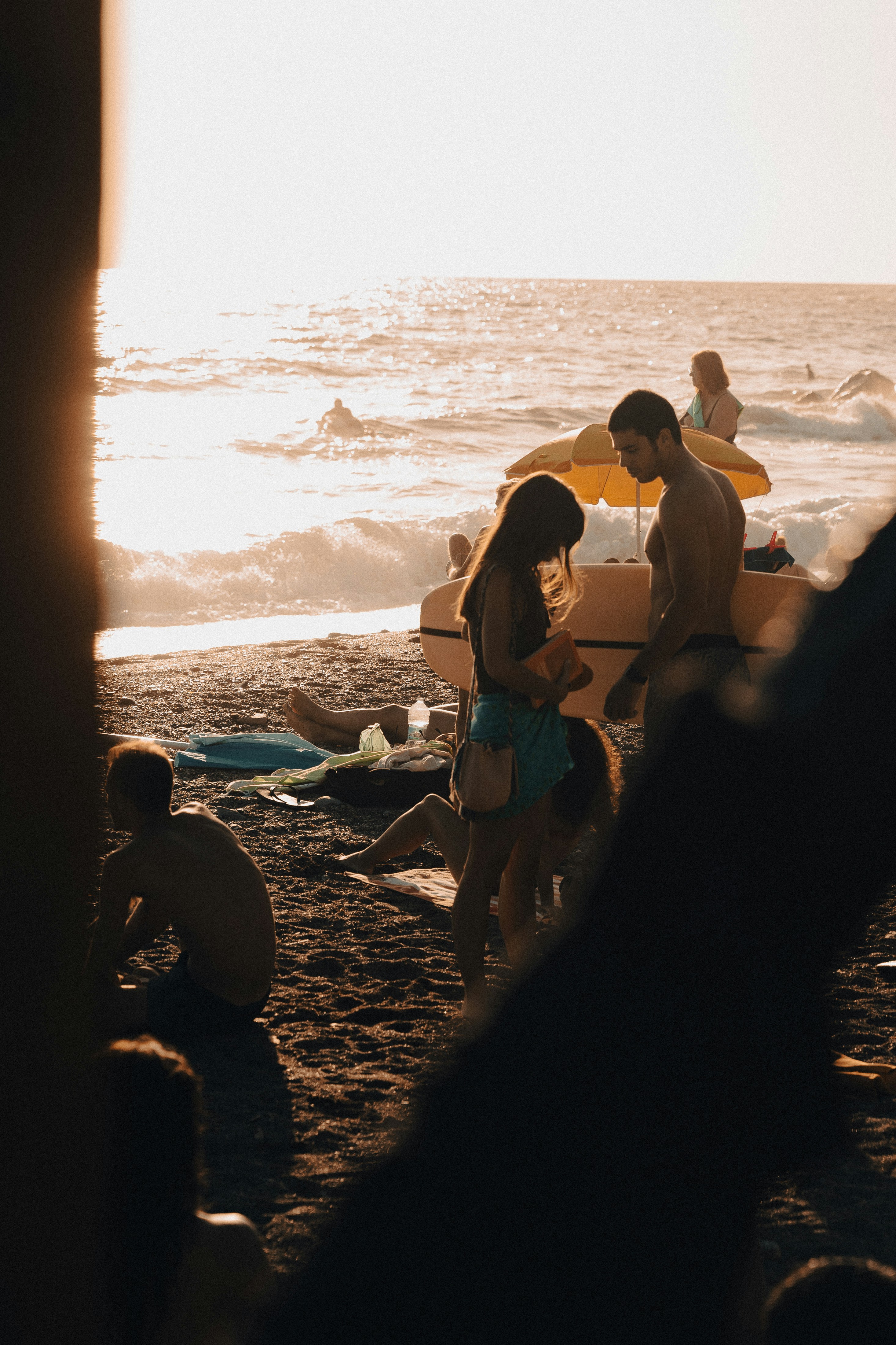 a group of people standing on top of a sandy beach