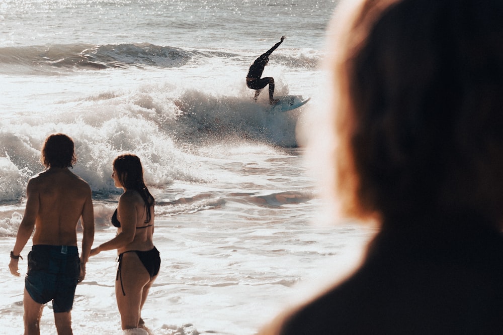 a couple of people that are standing in the water