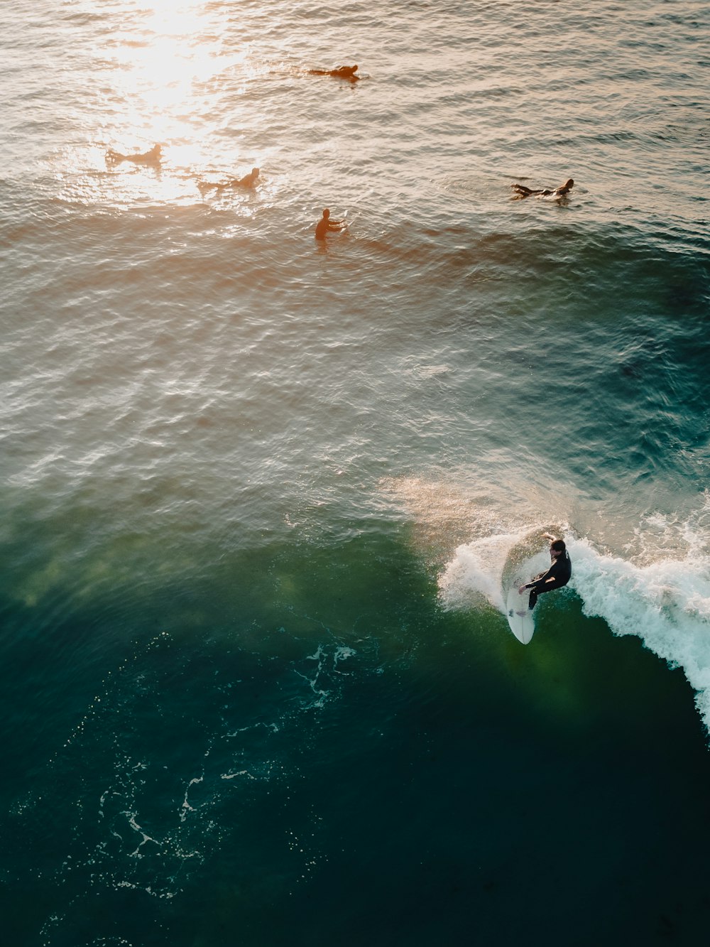 a man riding a wave on top of a surfboard