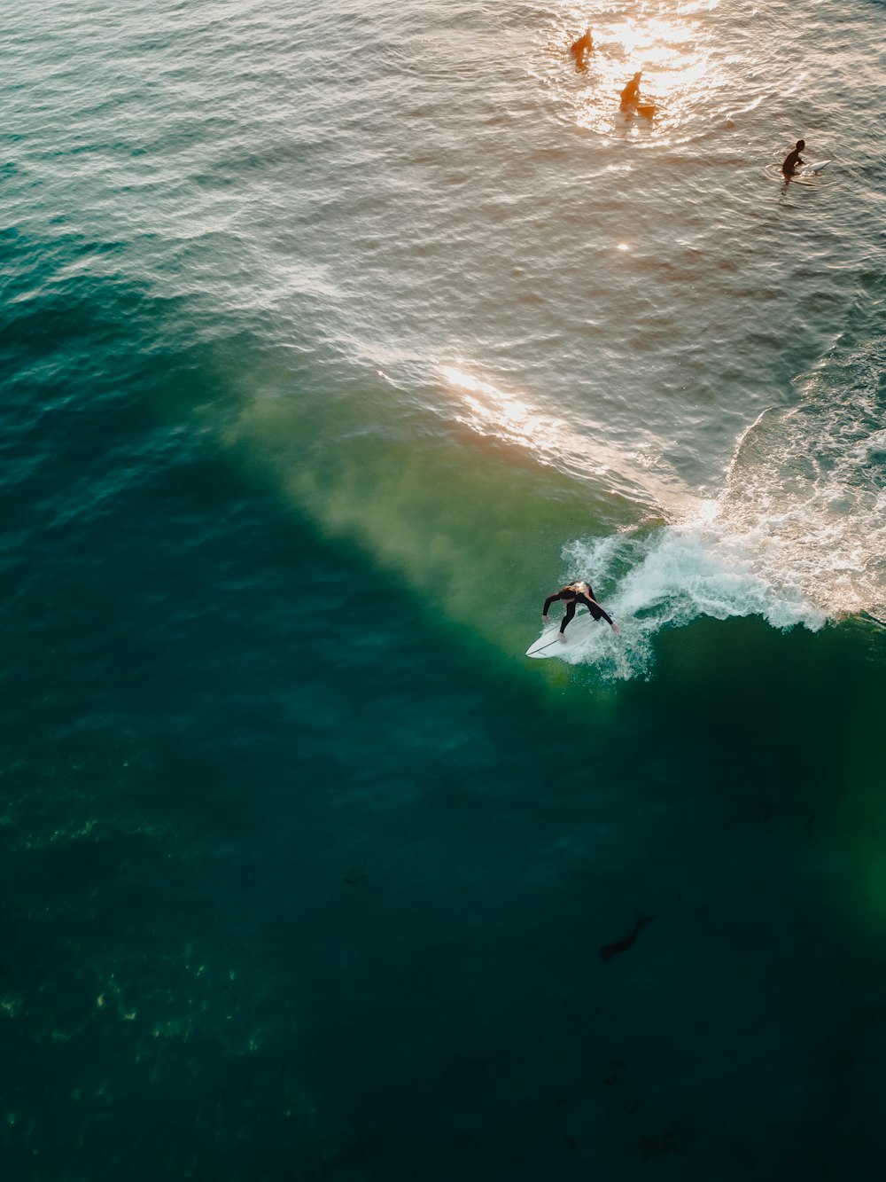 a man riding a wave on top of a surfboard