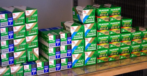 A stack of colorful instant film packs for instant cameras.