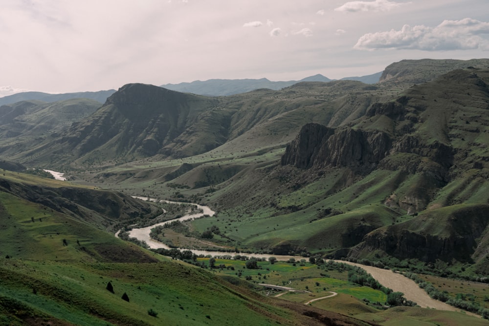 a river running through a lush green valley