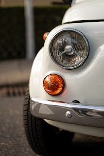 a close up of the front end of a white car