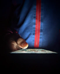 Close-up of a user’s hand holding a smartphone displaying the zipup.in app interface with local posts.
