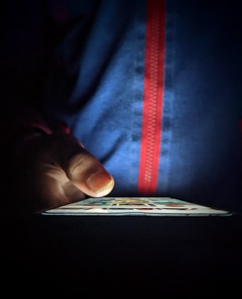 Close-up of a person scrolling through a dark-themed curiosity blog on a smartphone.