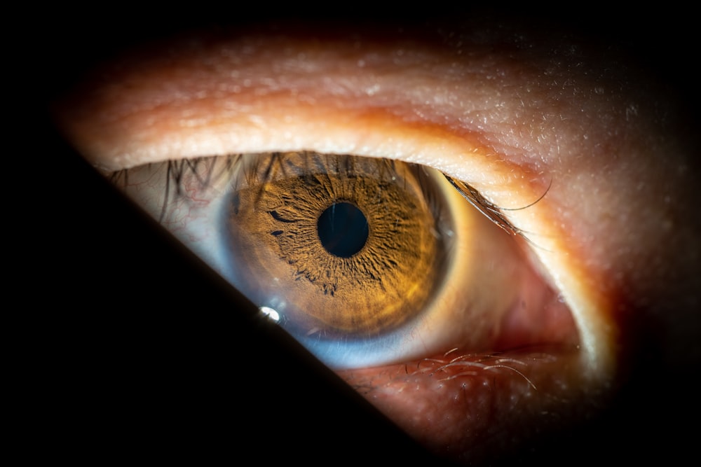 a close up of a person's brown eye