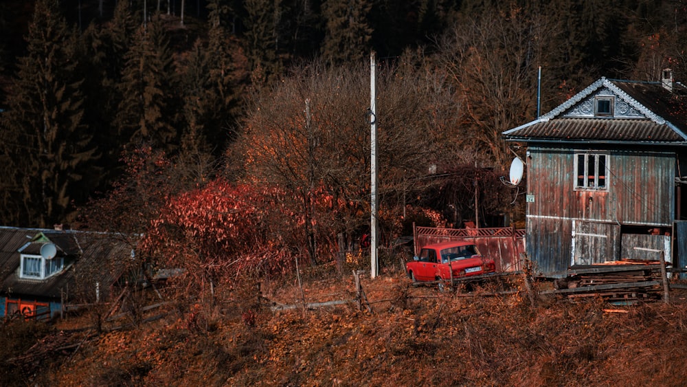 a red truck parked in front of a wooden building