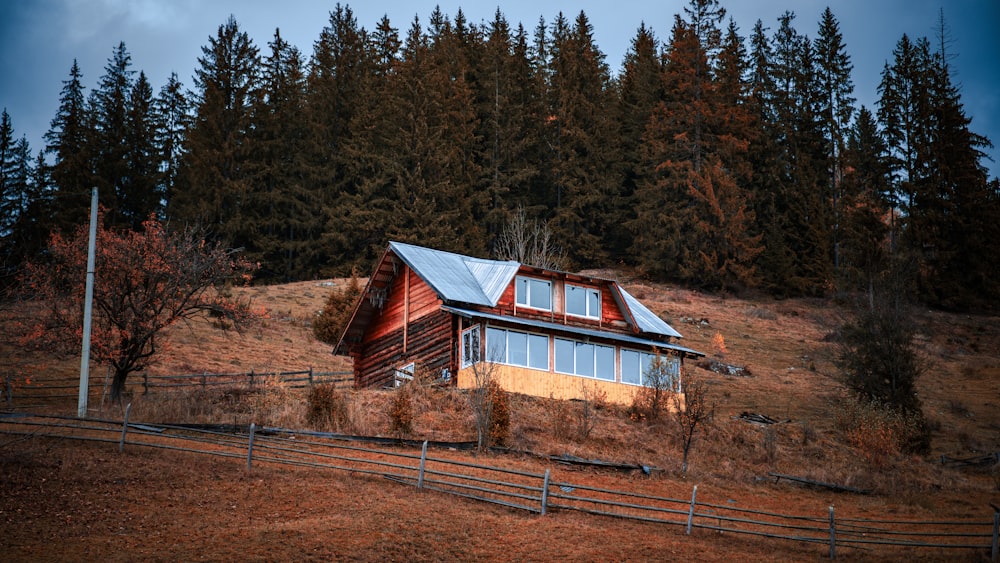 a house on a hill with trees in the background