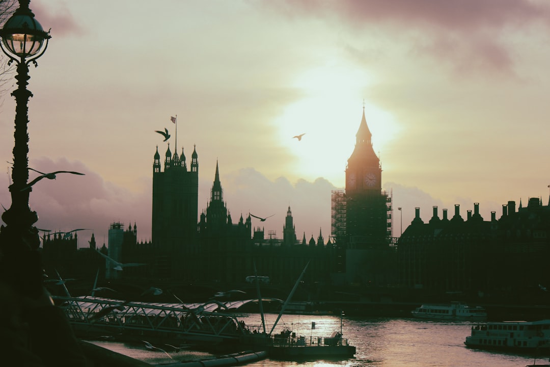 the sun is setting over the city of london,