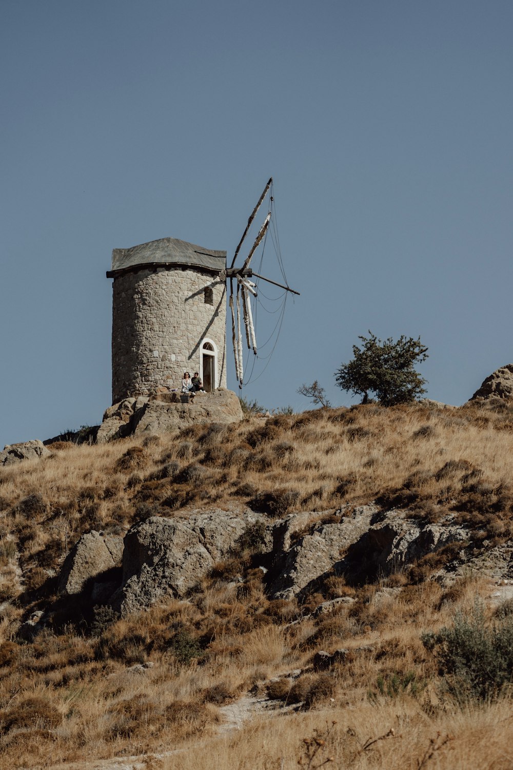 a windmill sitting on top of a hill