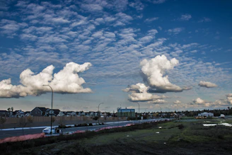 Wide shot of a completed kerb and channel project along a suburban street with clear skies.