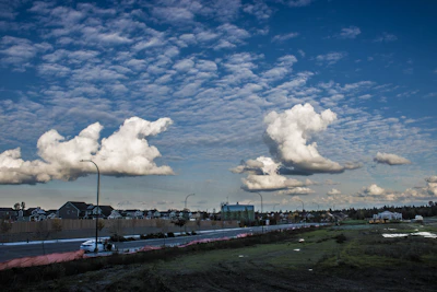 Wide shot of a completed kerb and channel project along a suburban street with clear skies.