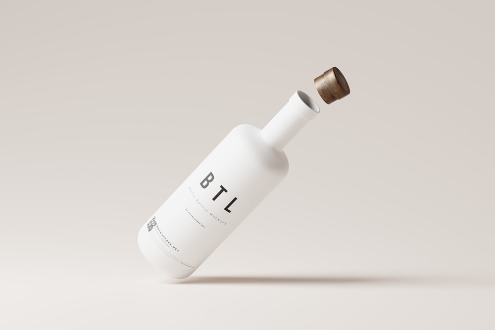 a white bottle with a brown cap on a white background