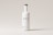 A tall white bottle with a minimalistic design is centered against a light gray background. The bottle features bold black letters spelling 'BTL' and additional smaller text below. It has a round wooden cap.