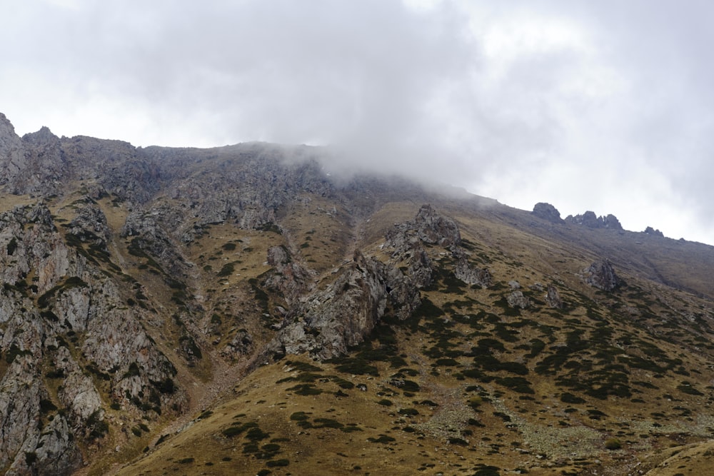 a very tall mountain covered in a cloud