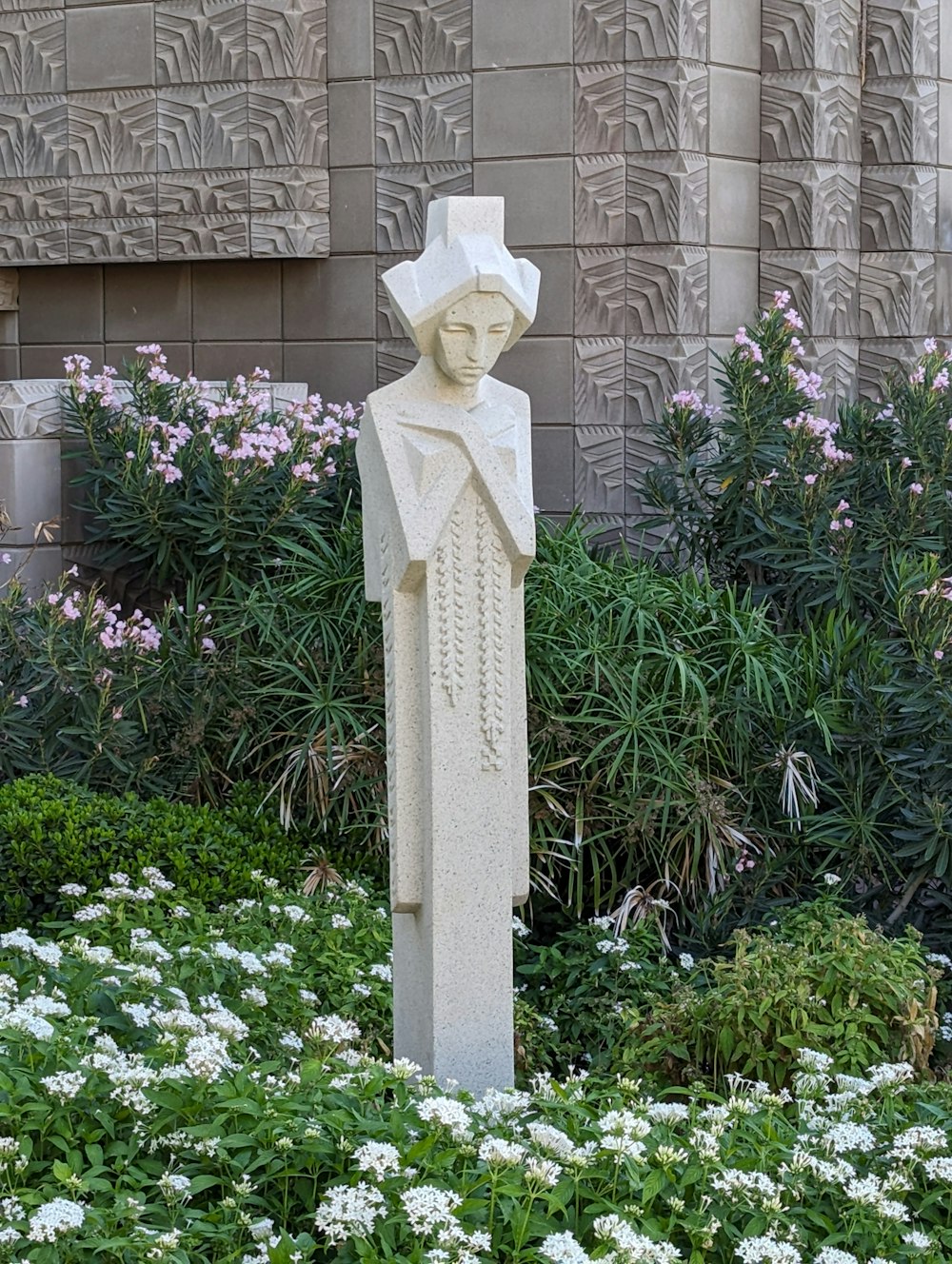 a statue of a woman standing in a garden