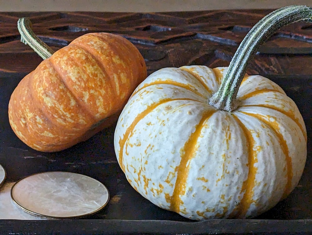 a couple of pumpkins sitting on top of a table