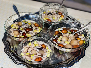 Assorted savory mixtures with nuts and spices in colorful bowls