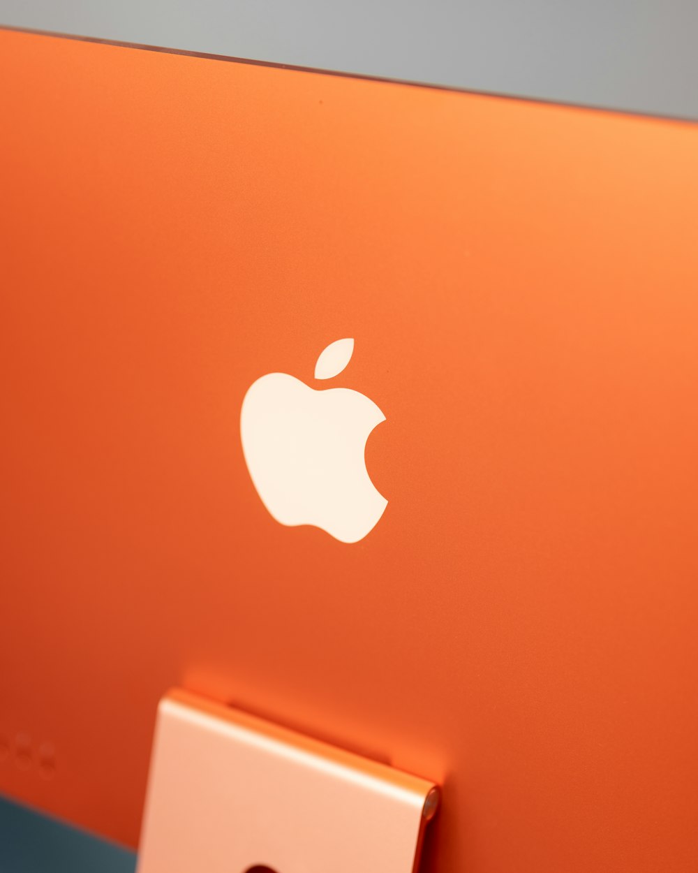 a close up of an orange apple computer