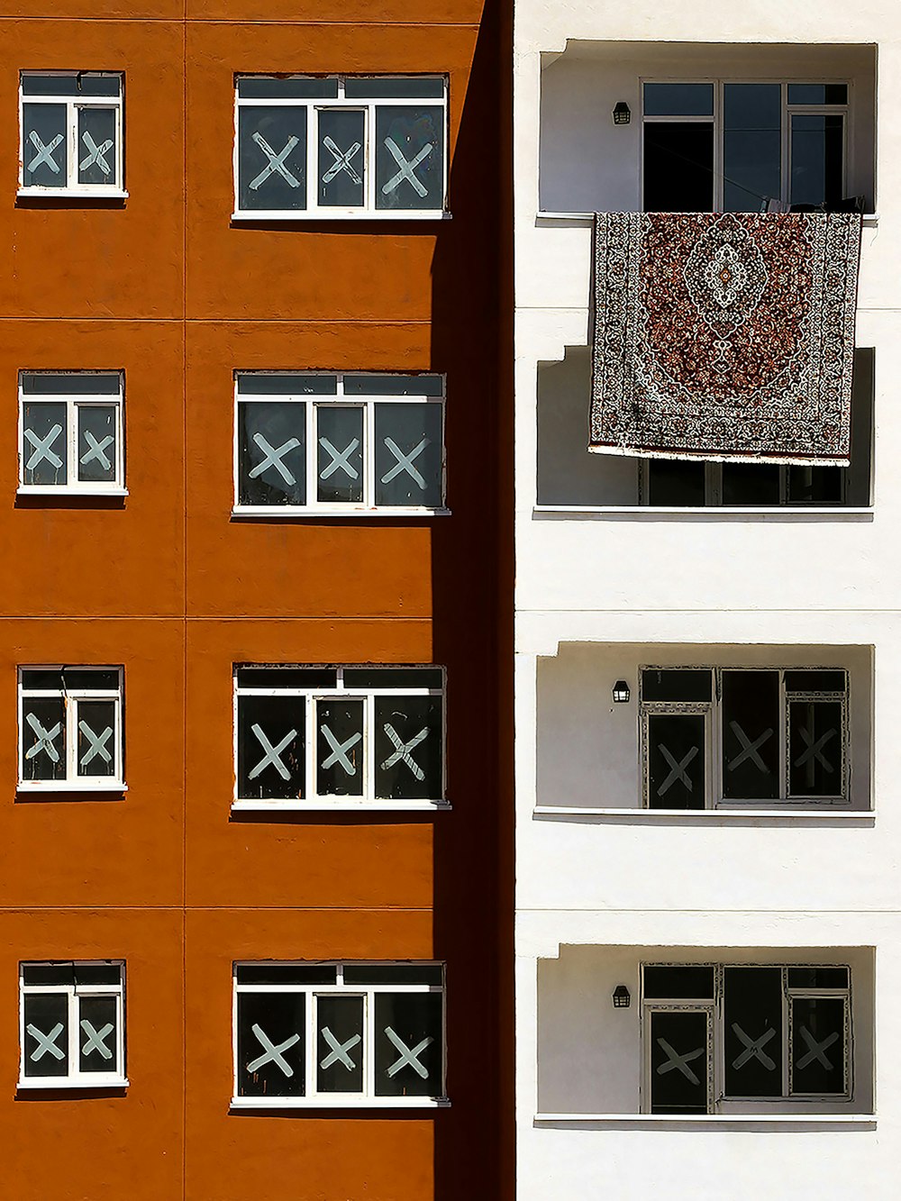 a building with a window and a rug hanging out of the window