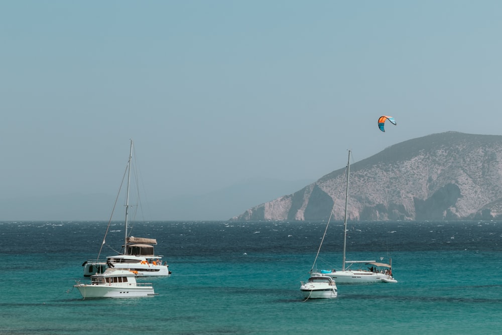 a group of boats floating on top of a body of water