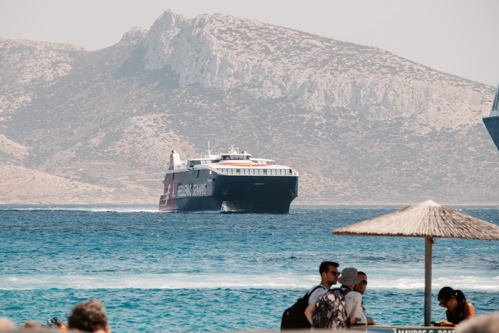 a cruise ship in the water near a beach