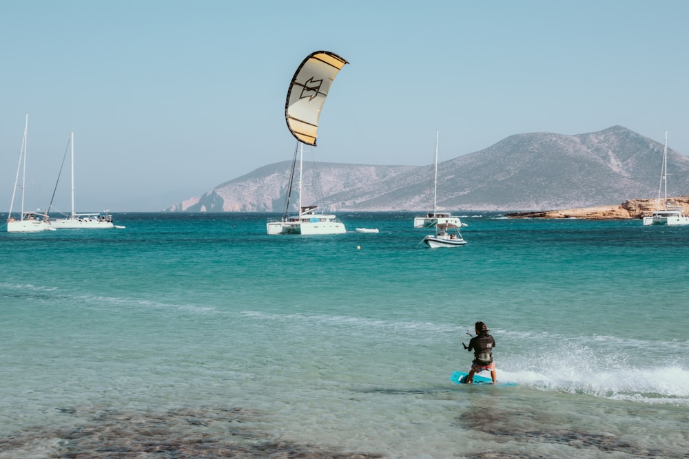 a person in the water with a kite