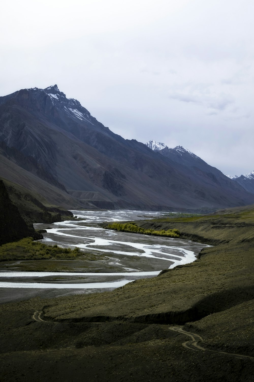 a river running through a lush green valley