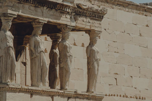a group of statues on the side of a building
