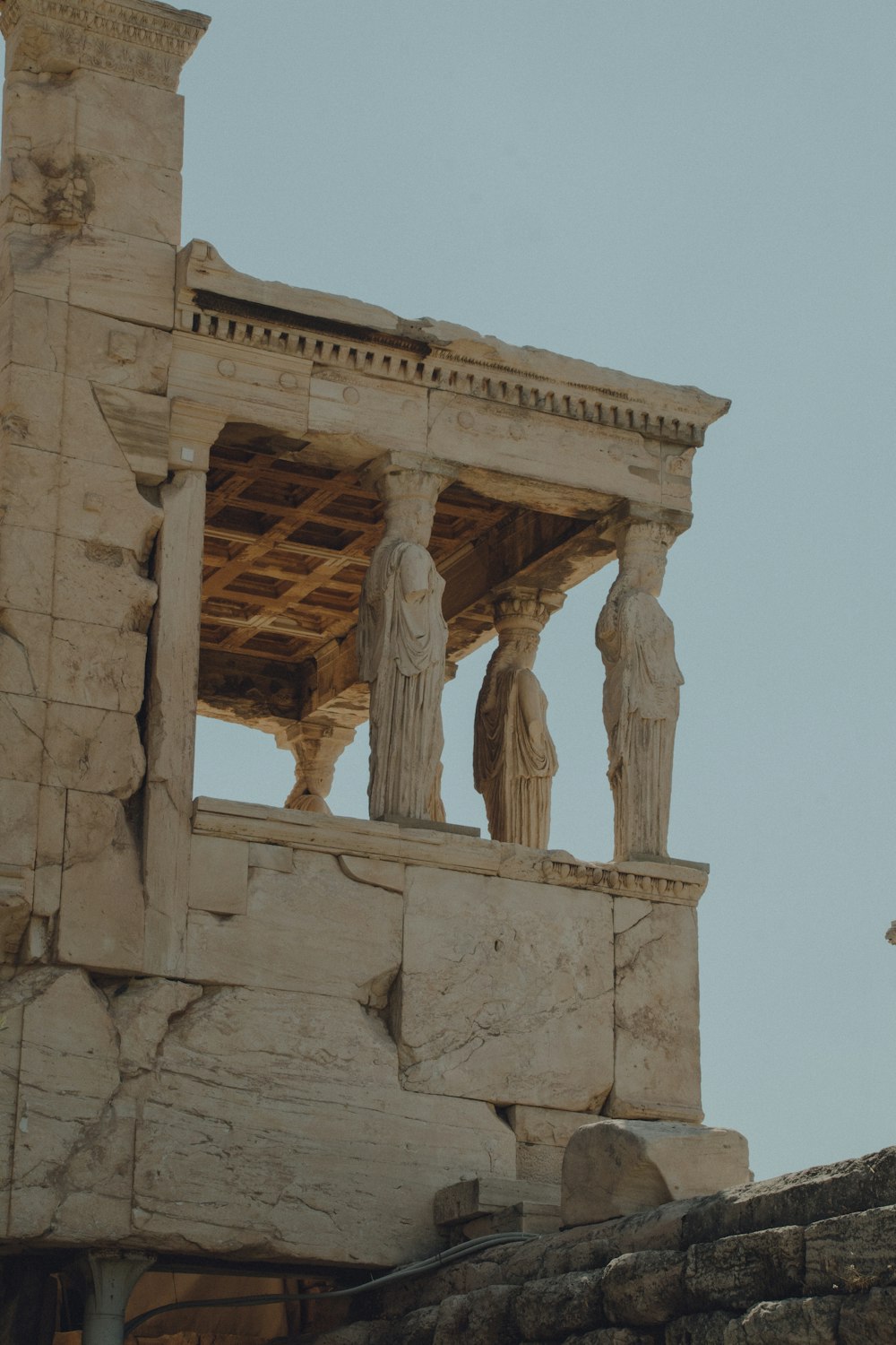 a stone structure with statues on top of it