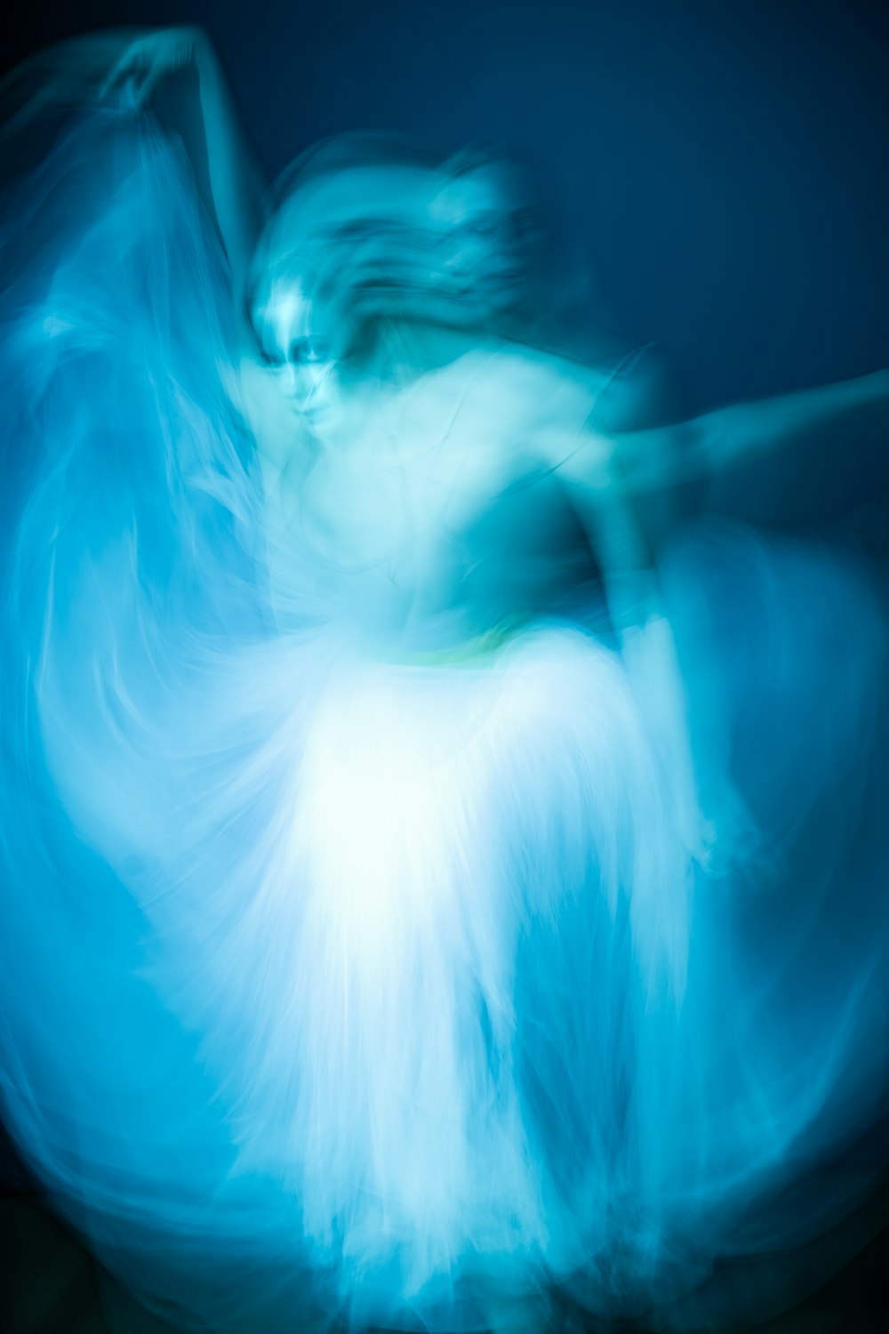 a blurry image of a woman in a white dress