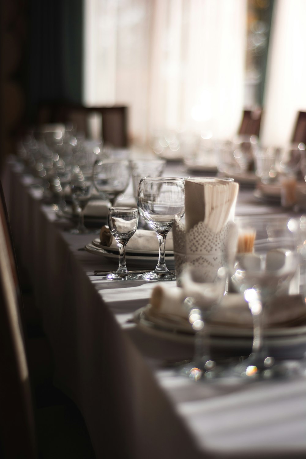 a long table is set for a formal dinner