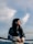 a woman standing on top of a metal rail