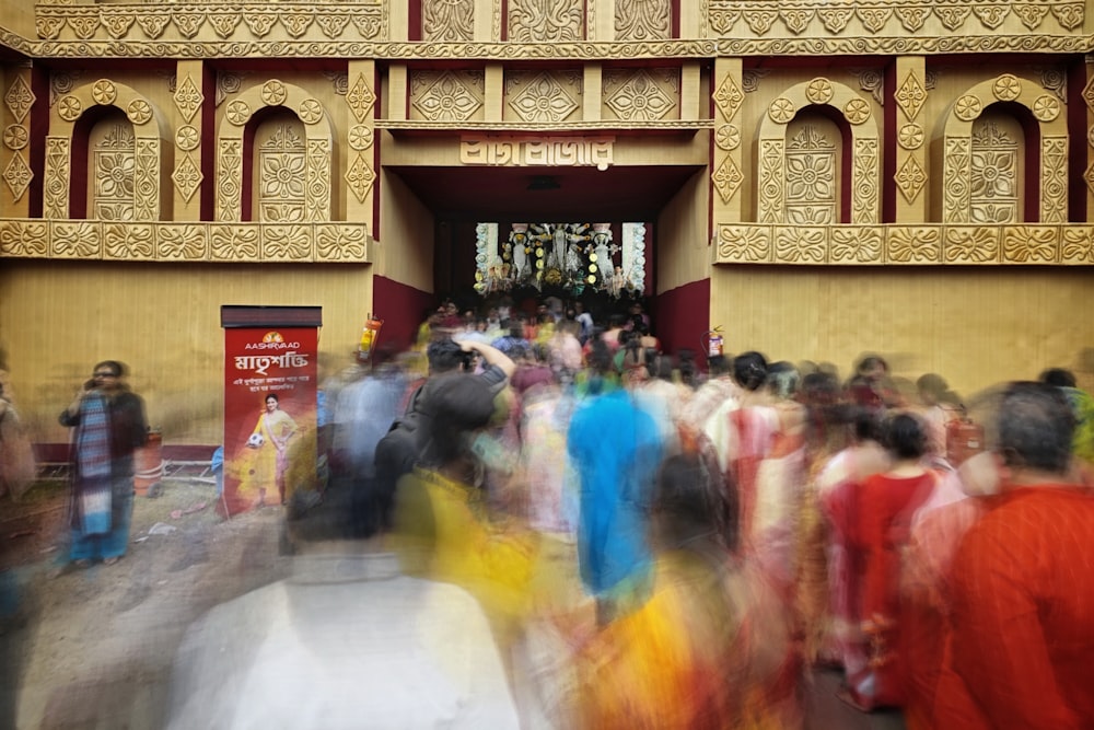 a large group of people walking in front of a building