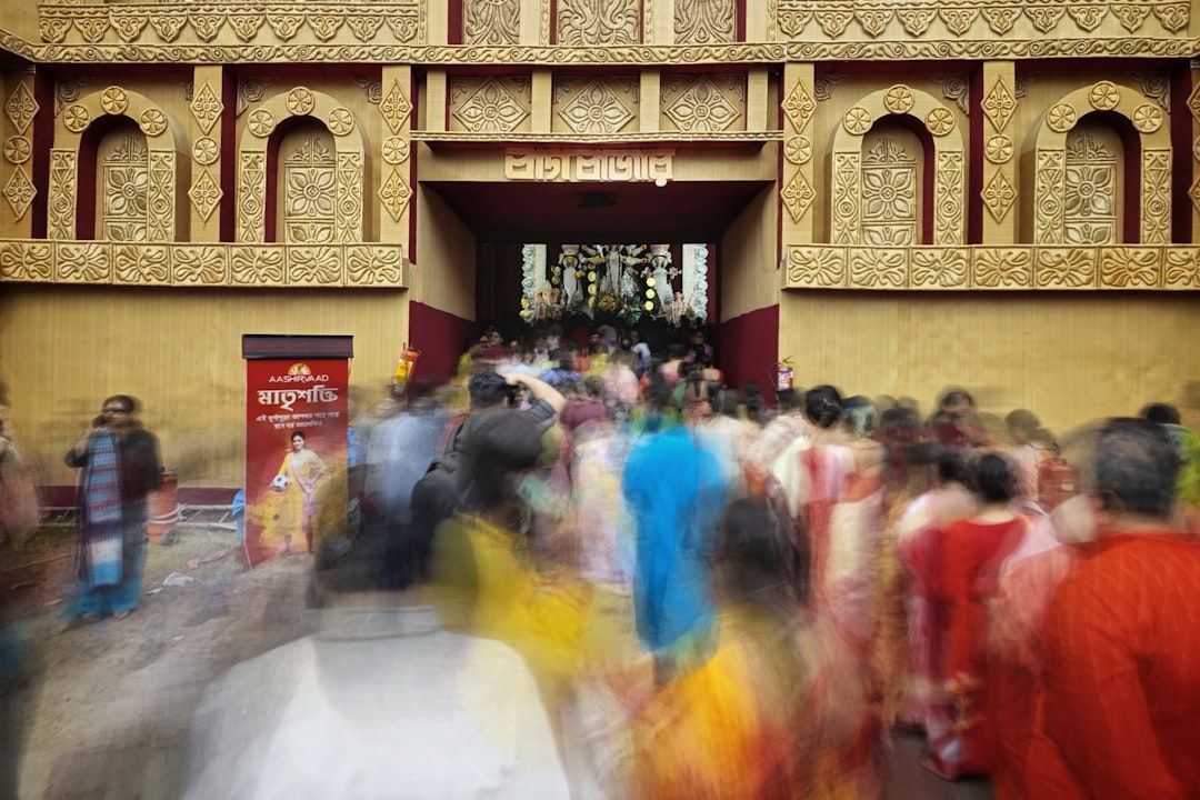 a large group of people walking in front of a building,