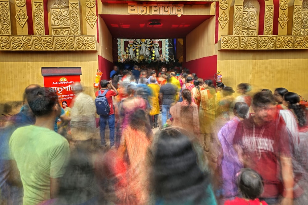 a crowd of people standing in front of a building