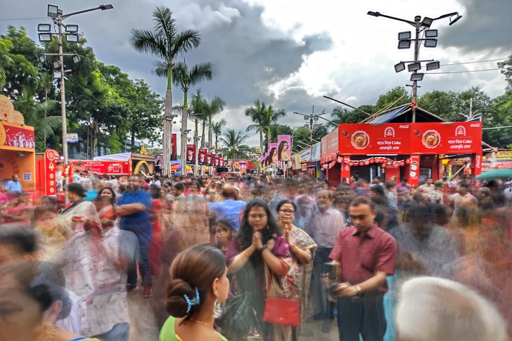 a crowd of people walking down a street