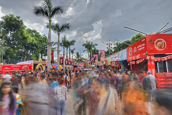 Colorful flyers being distributed to a crowd in a busy shopping area.