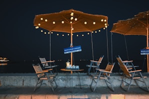 A cozy campsite scene featuring the lindacc foldable chair and umbrella setup at twilight